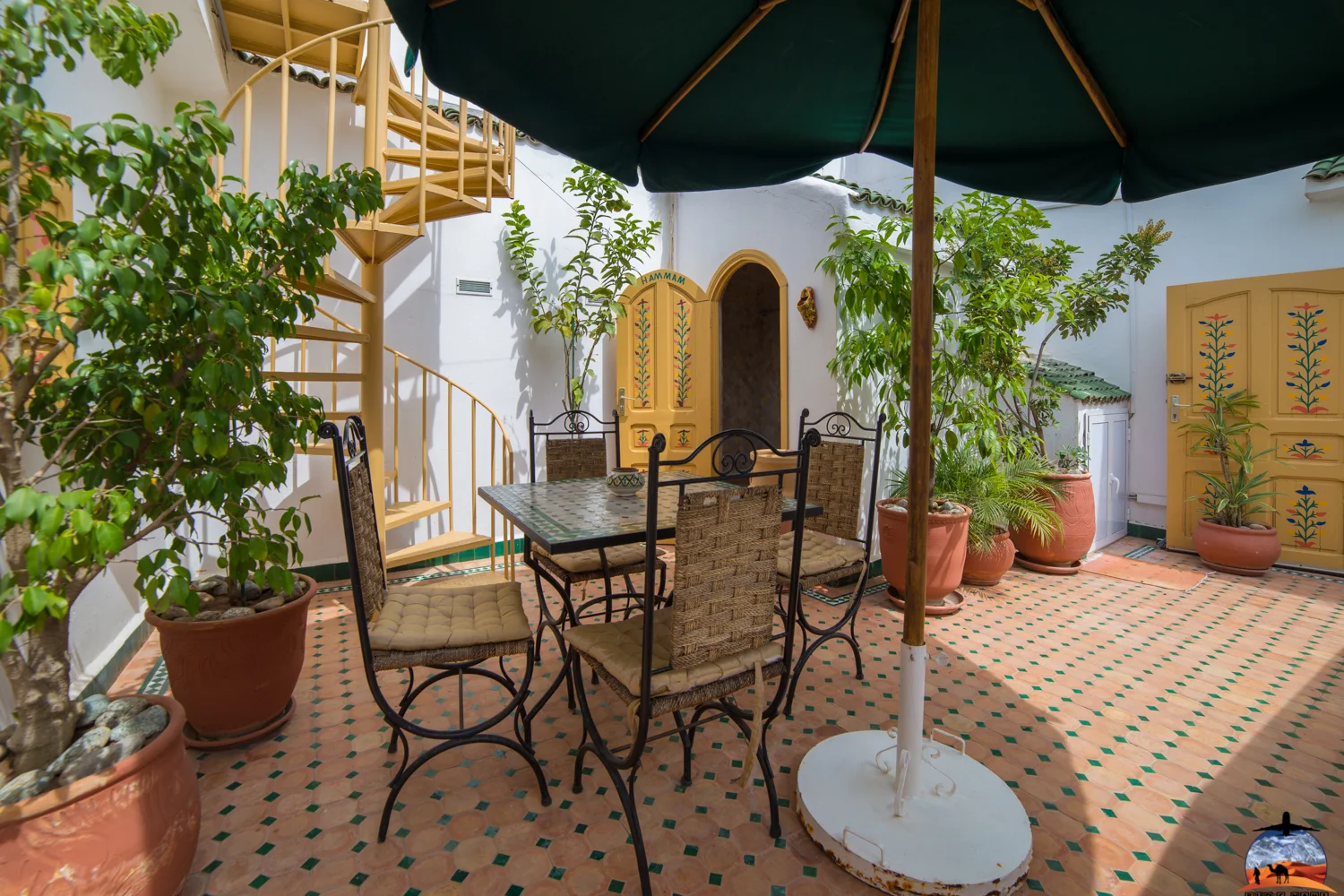 Terrace tables shaded by parasols in a riad