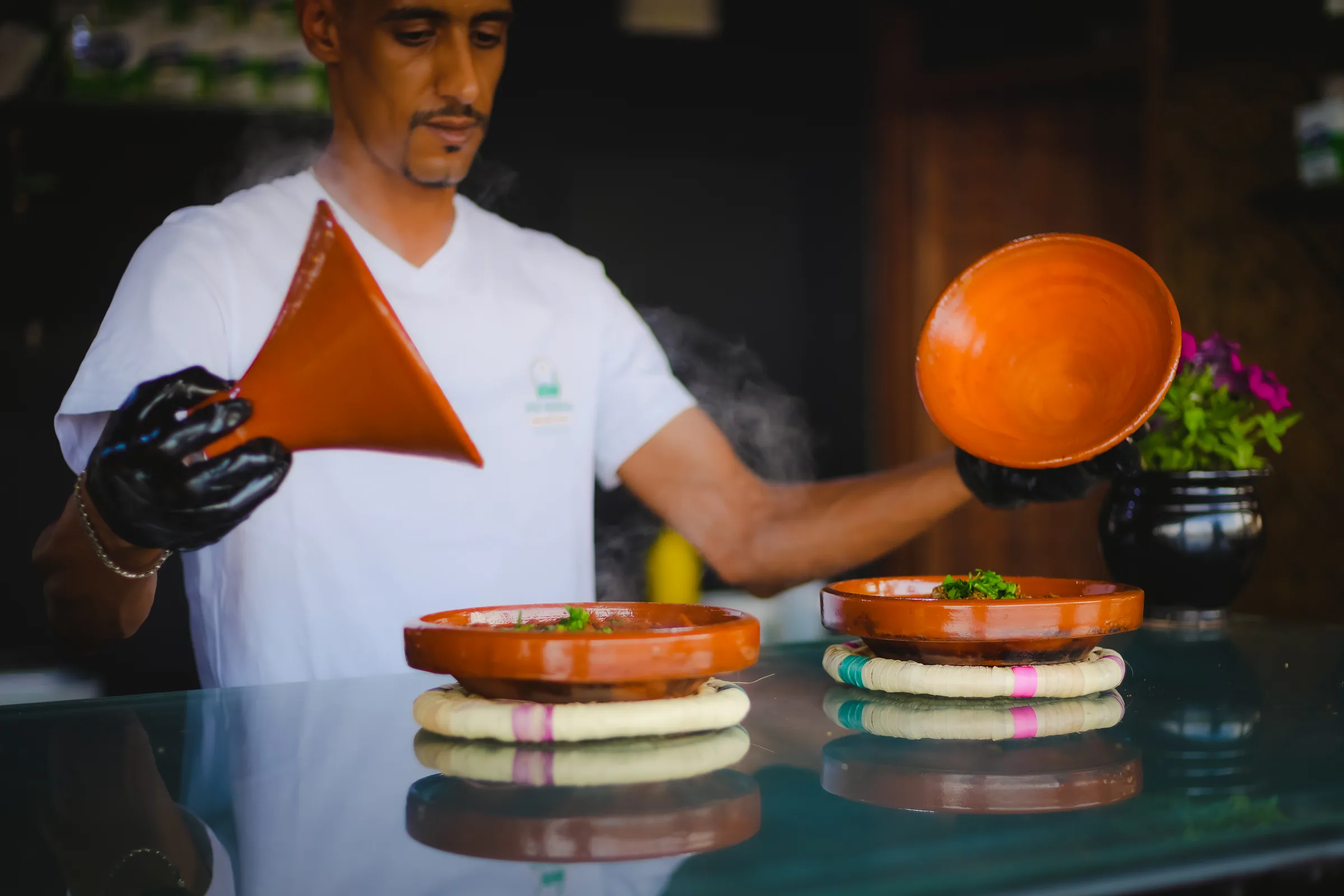 Opening two tagines at the counter