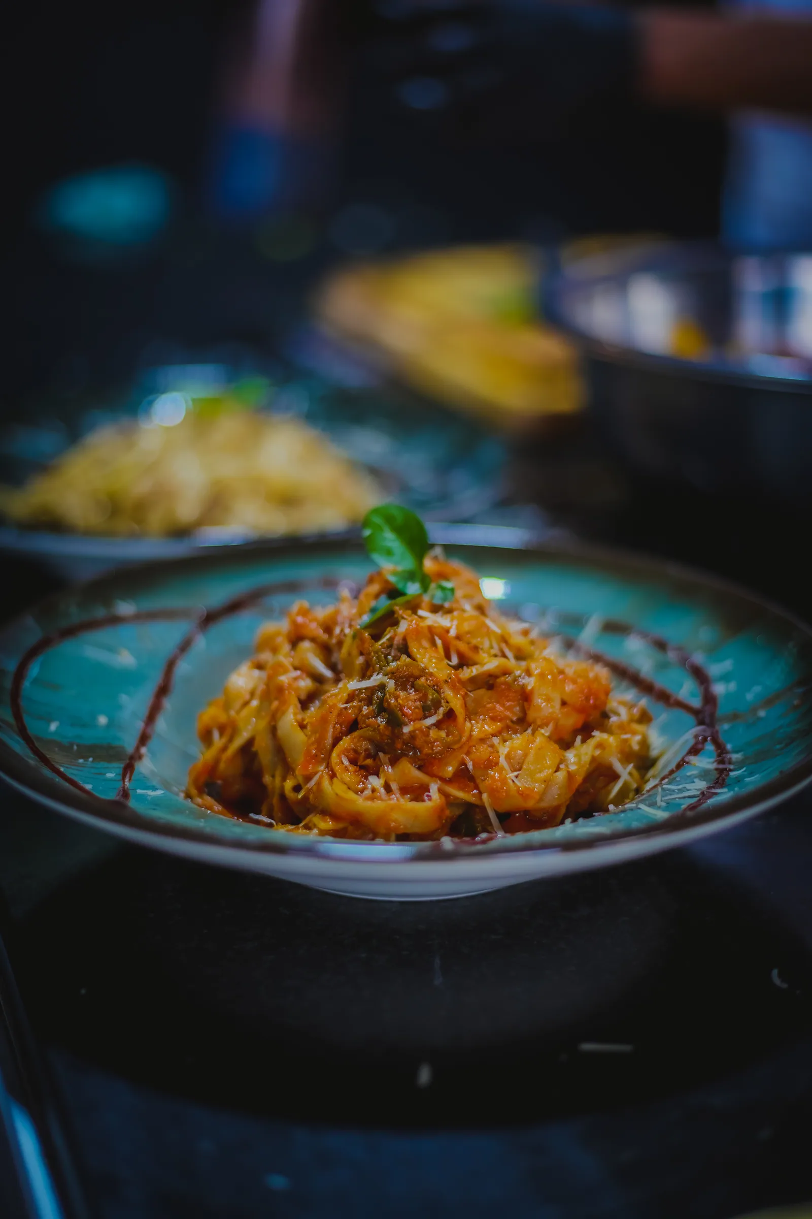Pasta dish photographed under restaurant lighting